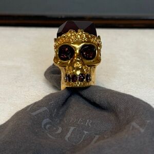 Alexander McQueen, Gold Skull Ring with ruby gems.